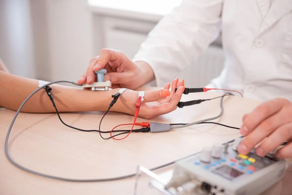 Healthcare professional placing electrodes for nerve and cardiac testing